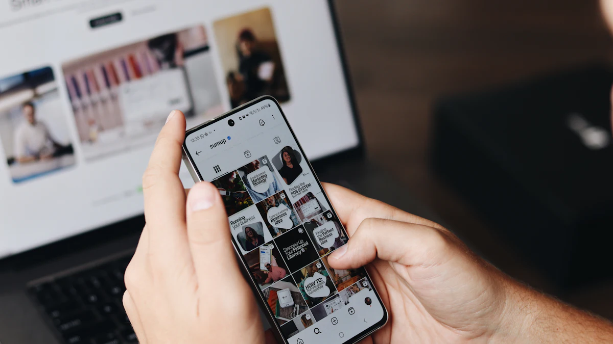 Person browsing social media on a phone in front of a laptop