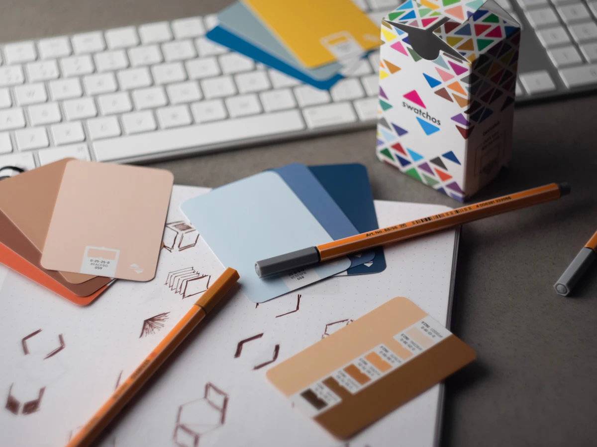 Designer desk with colour swatches, pencils and brand samples