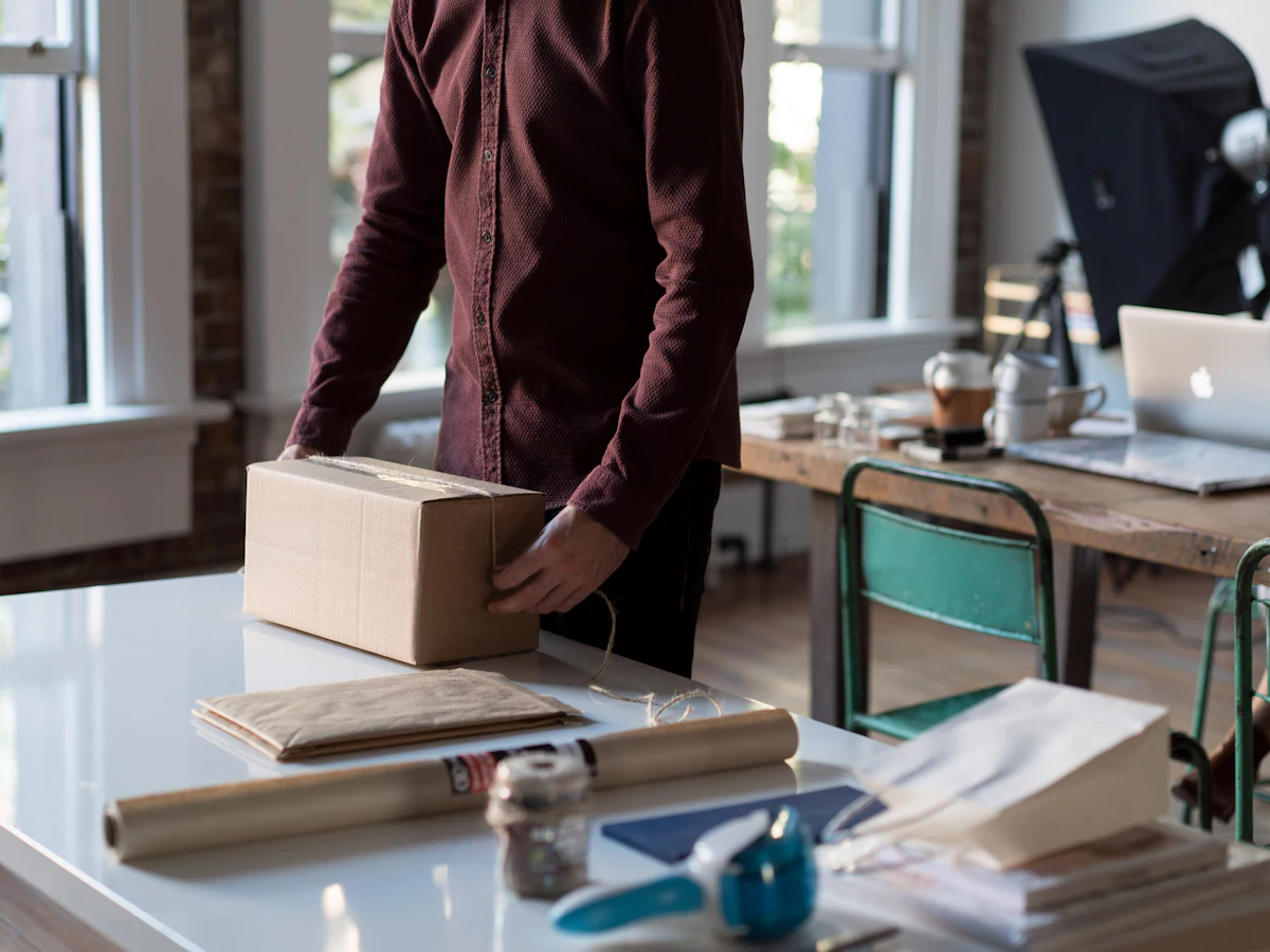 Small business owner packing an online order